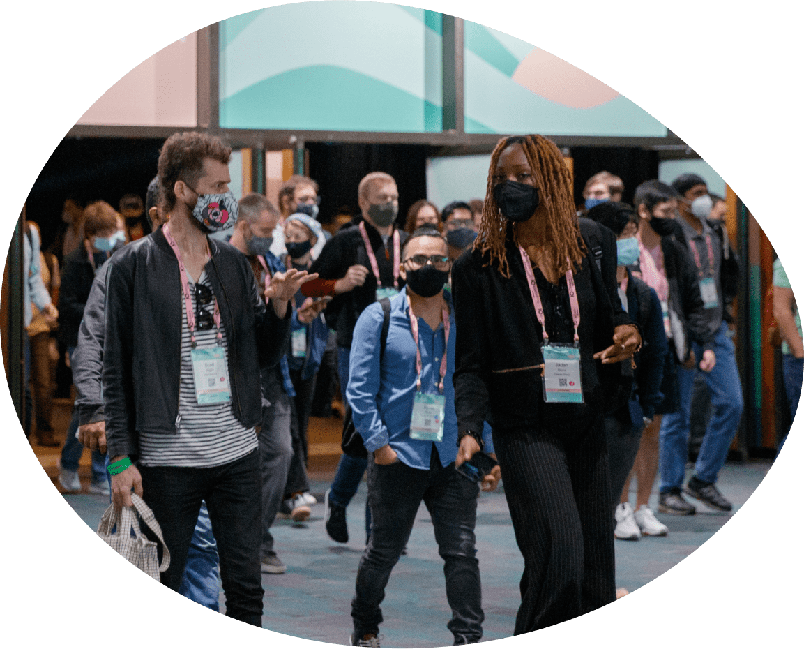 Masked people walking at conference