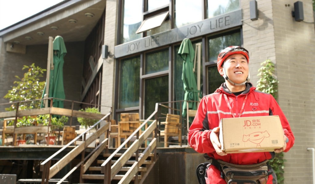 JD.com delivery man happily delivering JD.com package