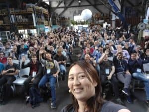 Cheryl Hung takes a selfie with audience in conference room