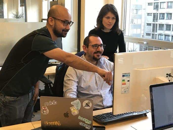 A gentleman pointing to his colleague's computer screen in an office