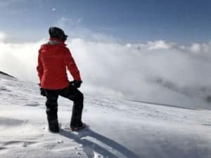 Kris Nova with her snowboard on a mountain