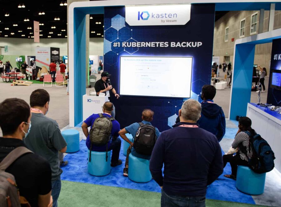 People watching a presentation at a sponsor booth