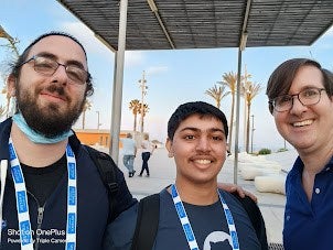 Three gentlemen in blue shirt