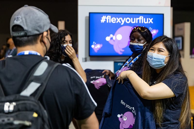 Ladies in mask promoting flex your flux t-shirts to a gentleman