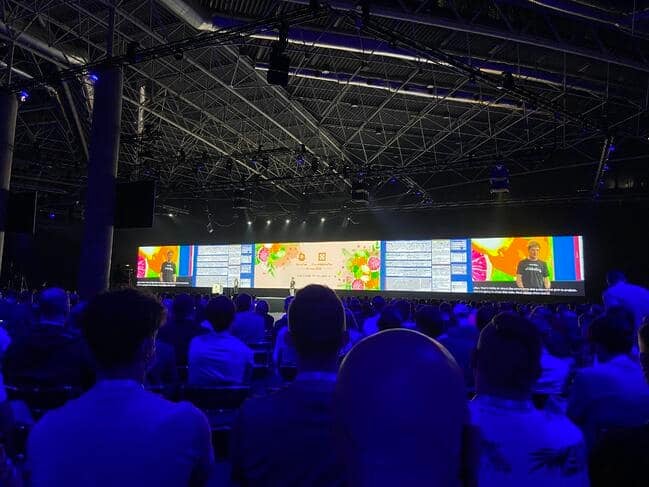 Audience paying attention to KubeCon + CloudNativeCon Europe 2022 speaker on the stage