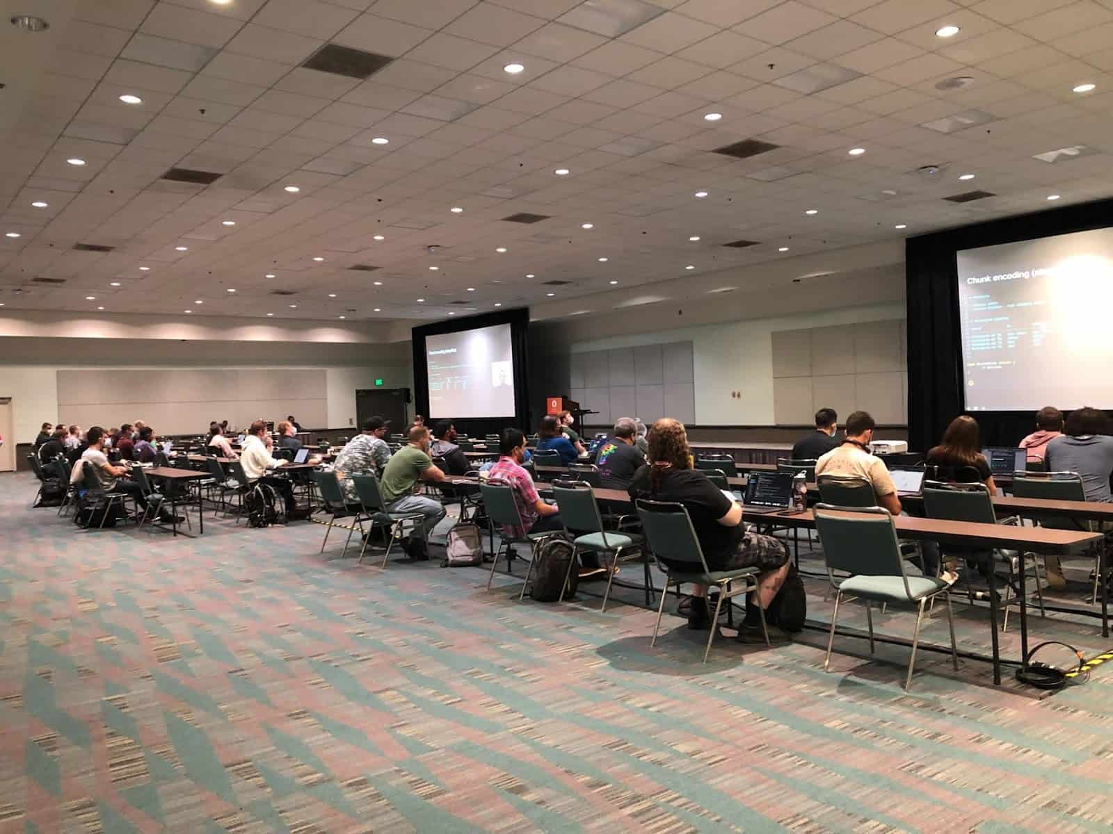 Participants looking presentation on screen projector in a room