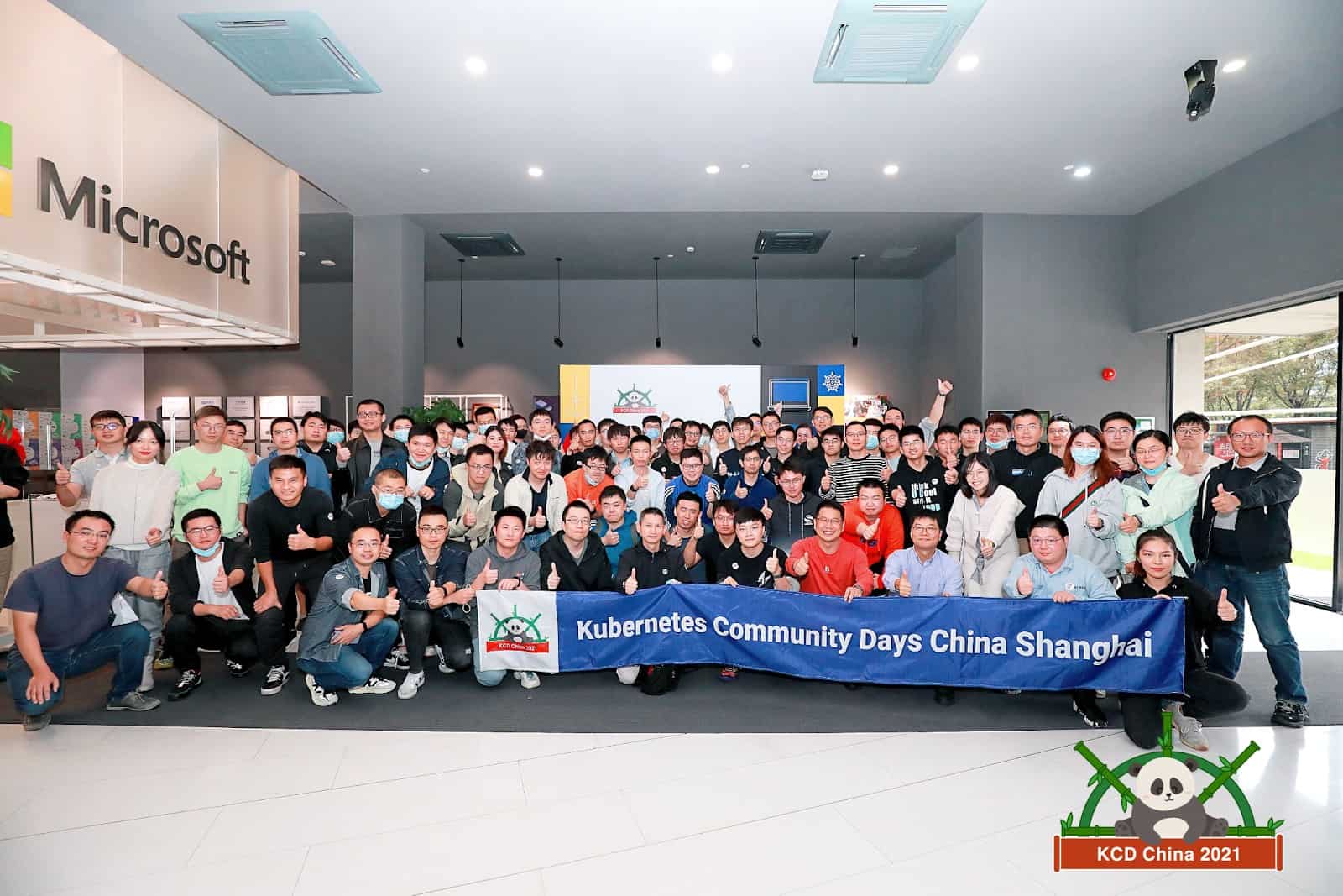 Participants of Kubernetes Community Days posing to camera with KCD China Shanghai banner in the Microsoft Shanghai office