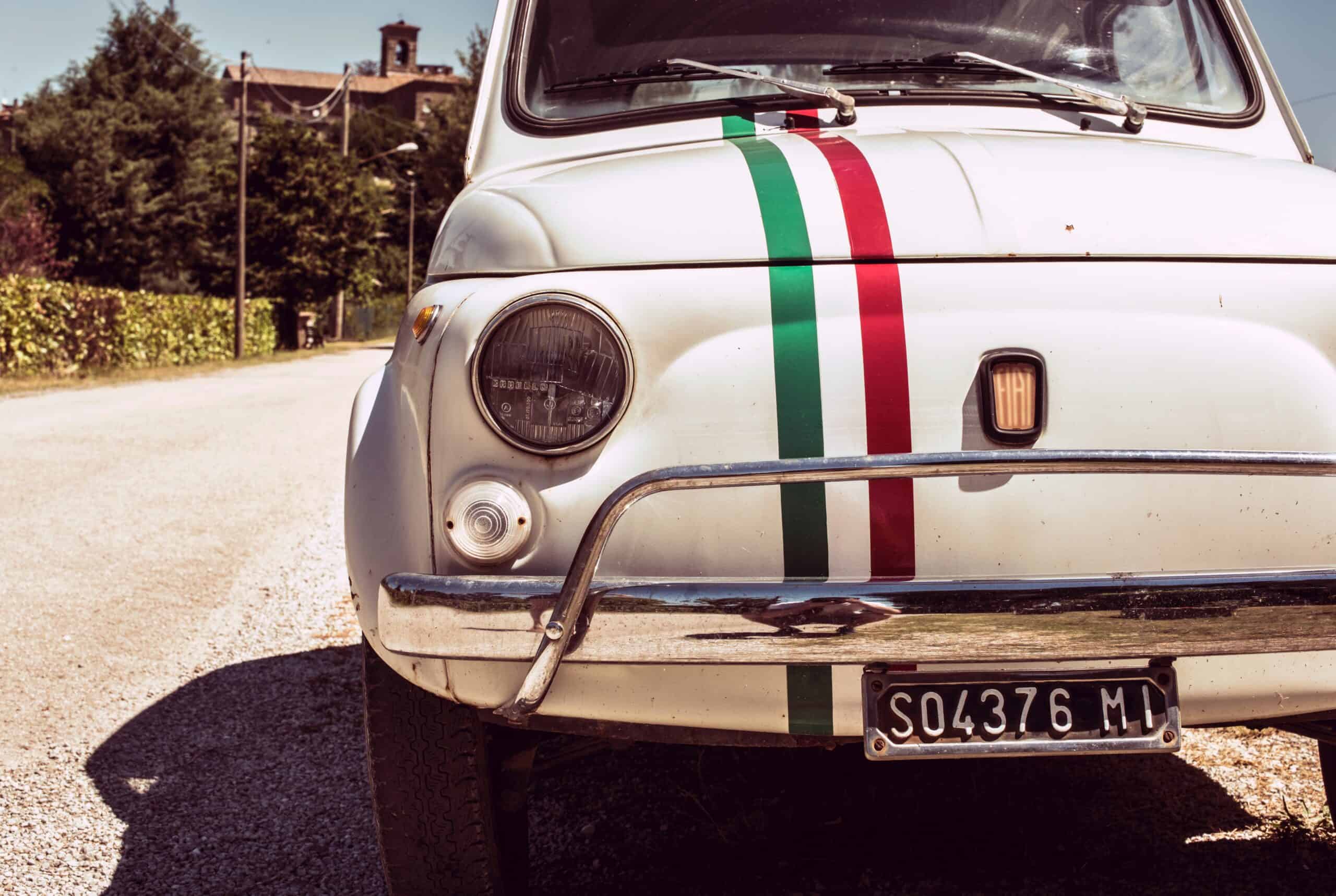 Images shows original, white Fiat 500 with Italian flag decal