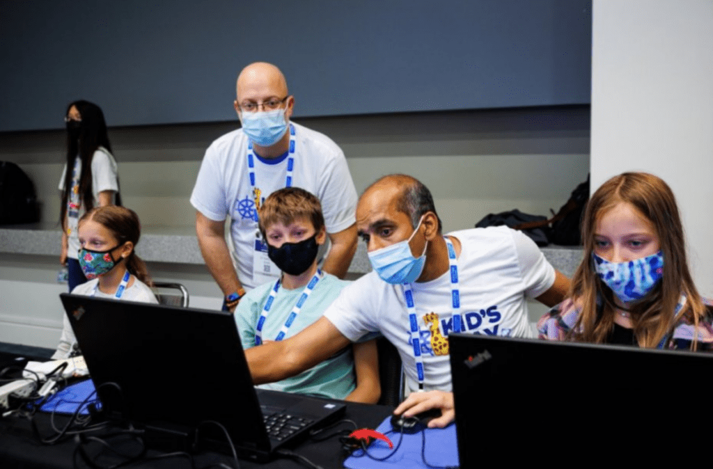 Man showing boy how to do something on computer