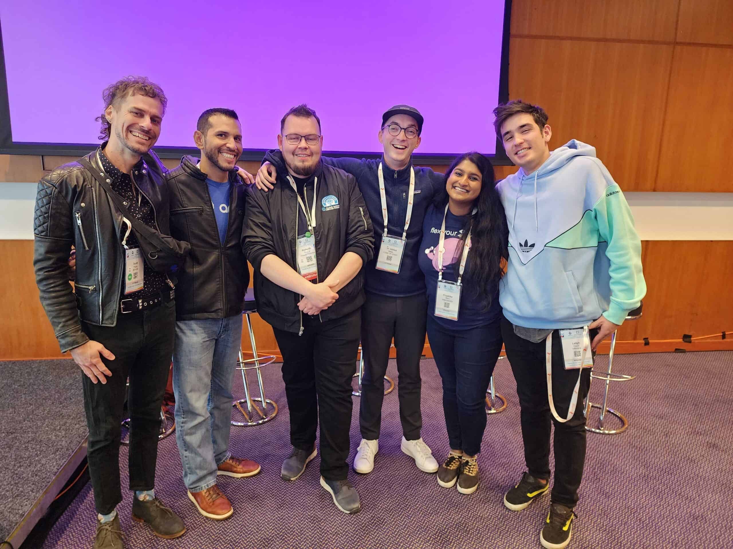 A lady and gentlemen taking group picture in the meeting room