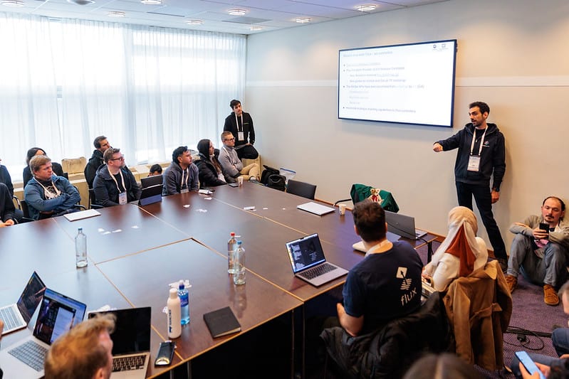 A gentleman giving presentation in the meeting room