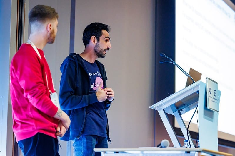 Two gentlemen giving presentation on the stage