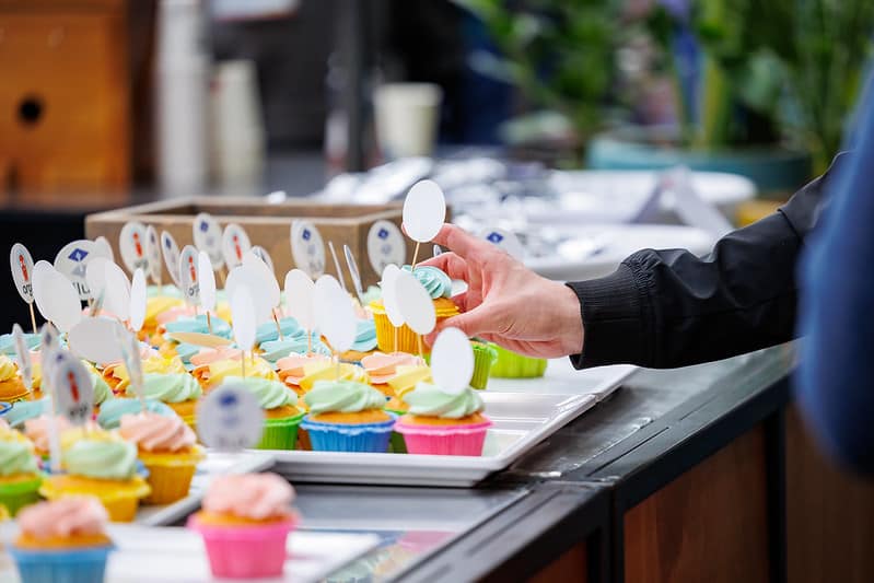 One participant getting one of the colorful argo and flux cupcakes