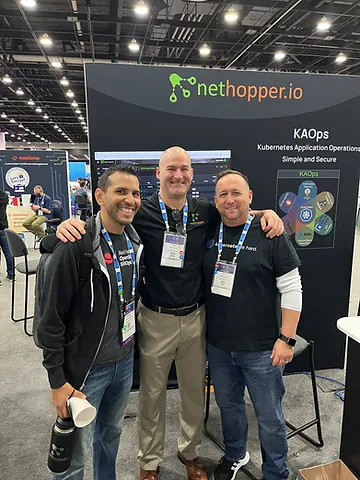 Dan Donahue, Christian and another gentleman taking picture together in front of nethopper.io booth