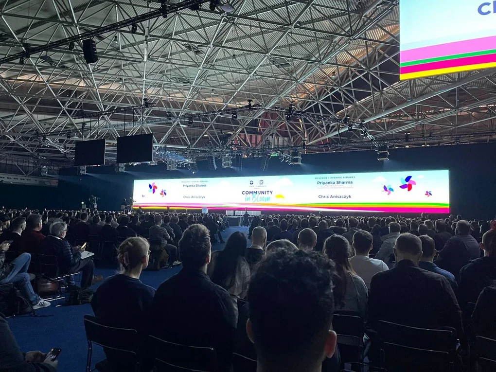 Participants sitting in the hall watching KubeCon keynotes