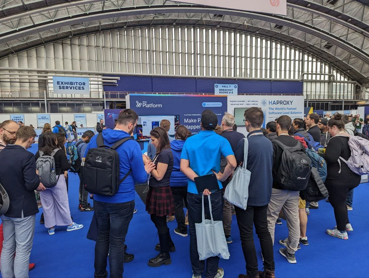 Participants surround Mia-Platform booth