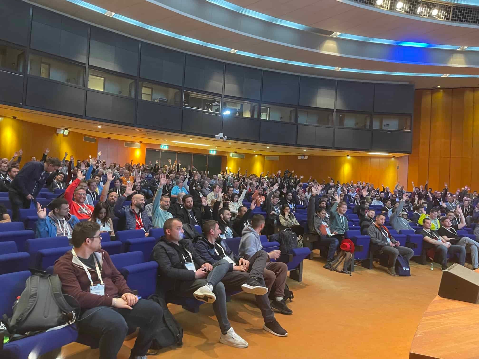 Some of the participants raising their hands in the event hall