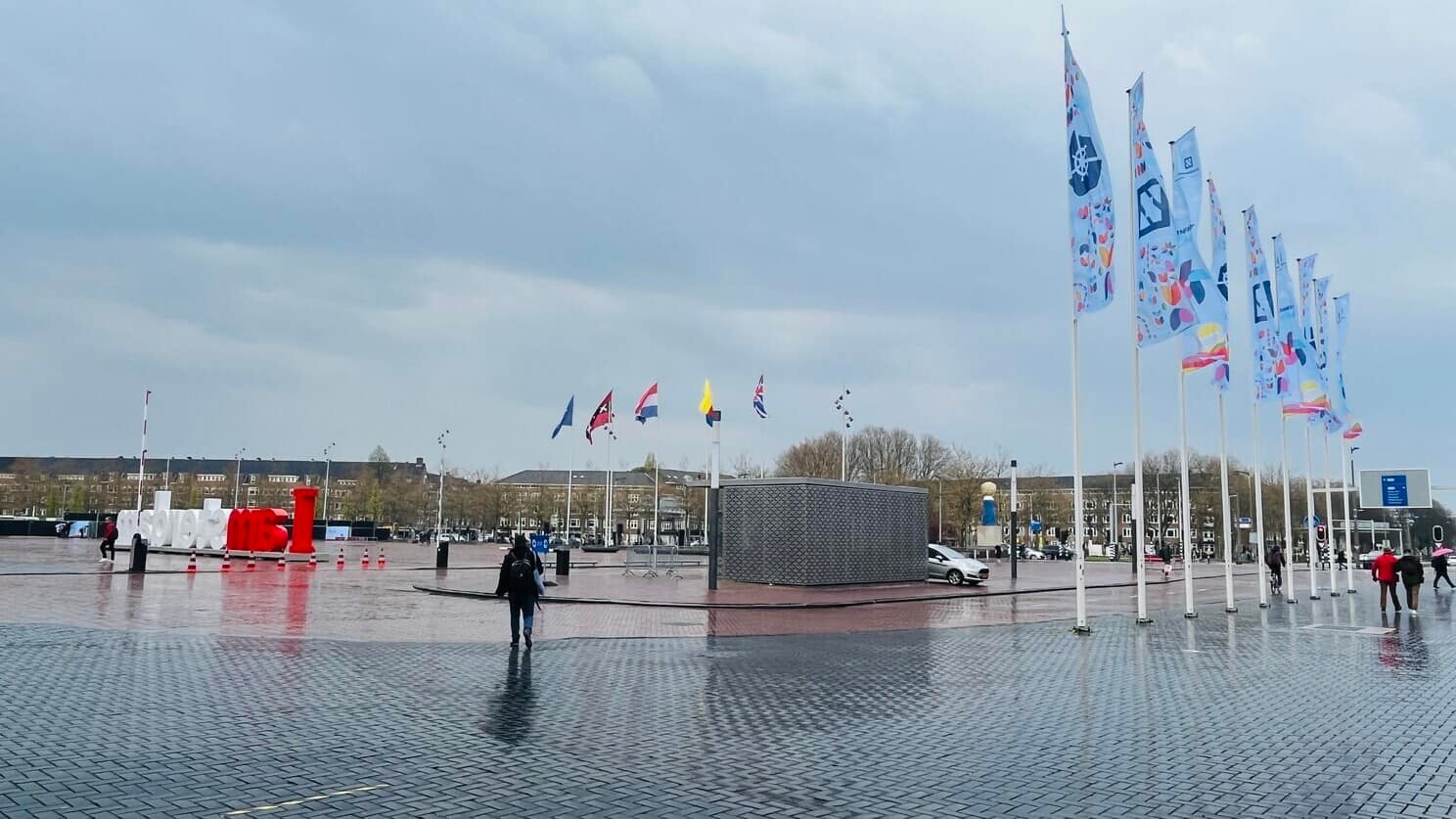 Rainy day in Amsterdam with KubeCon + CloudNativeCon event flag