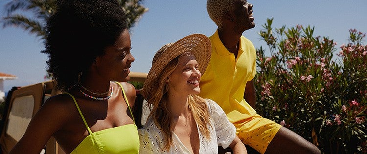 Defacto fashion modelled by two women and one man, sitting outside