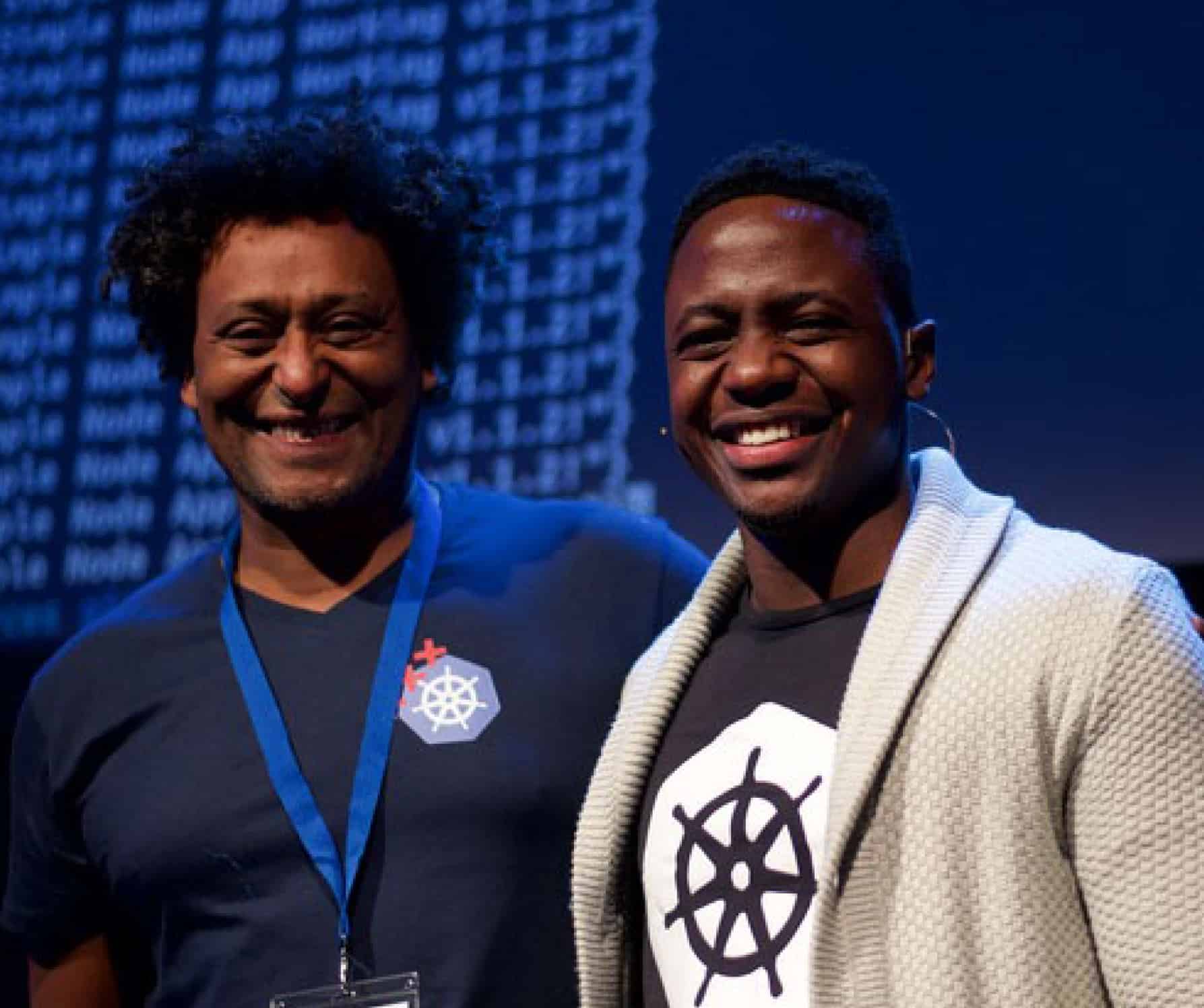 Two men smiling at a conference