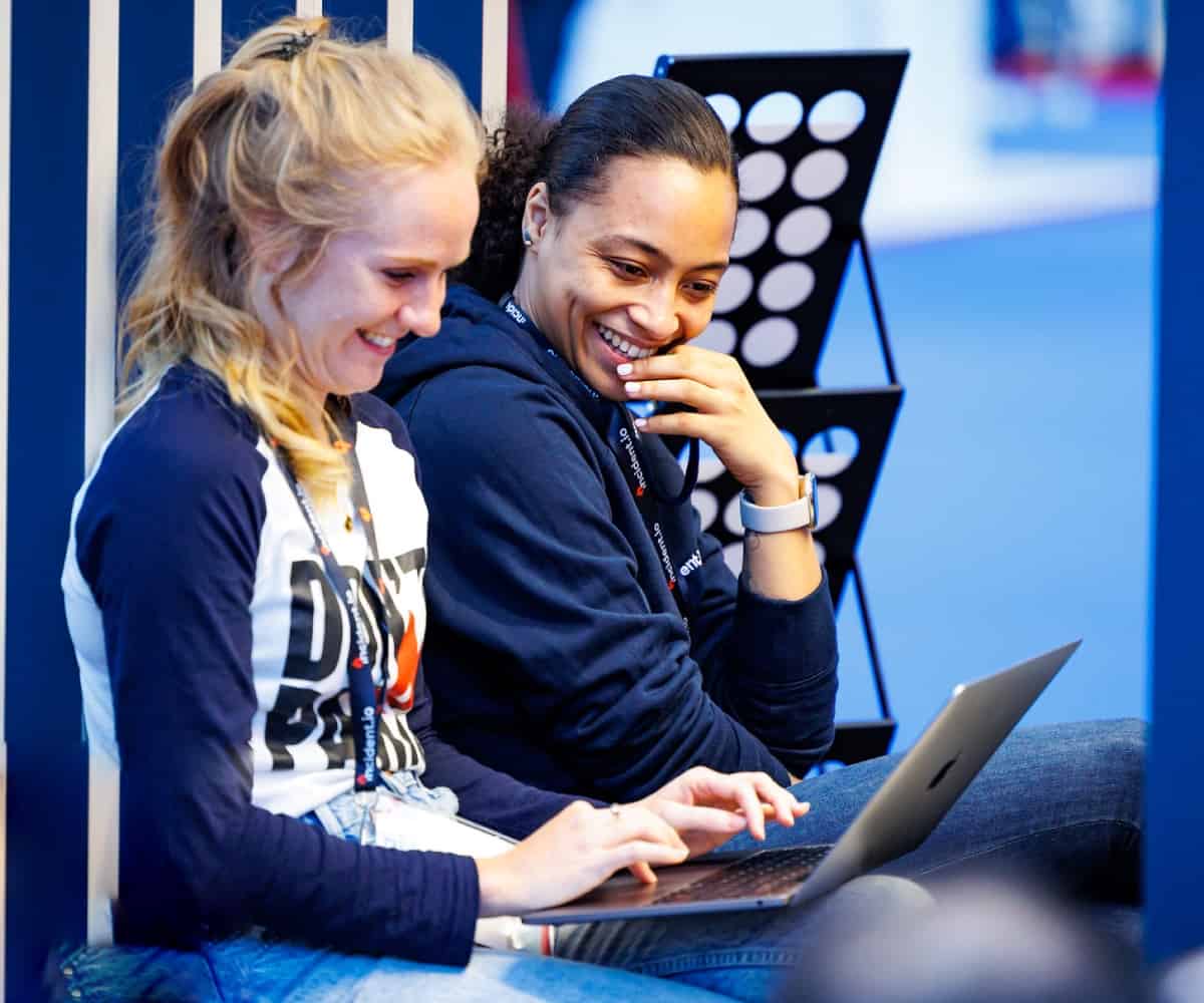 Two people looking at a laptop