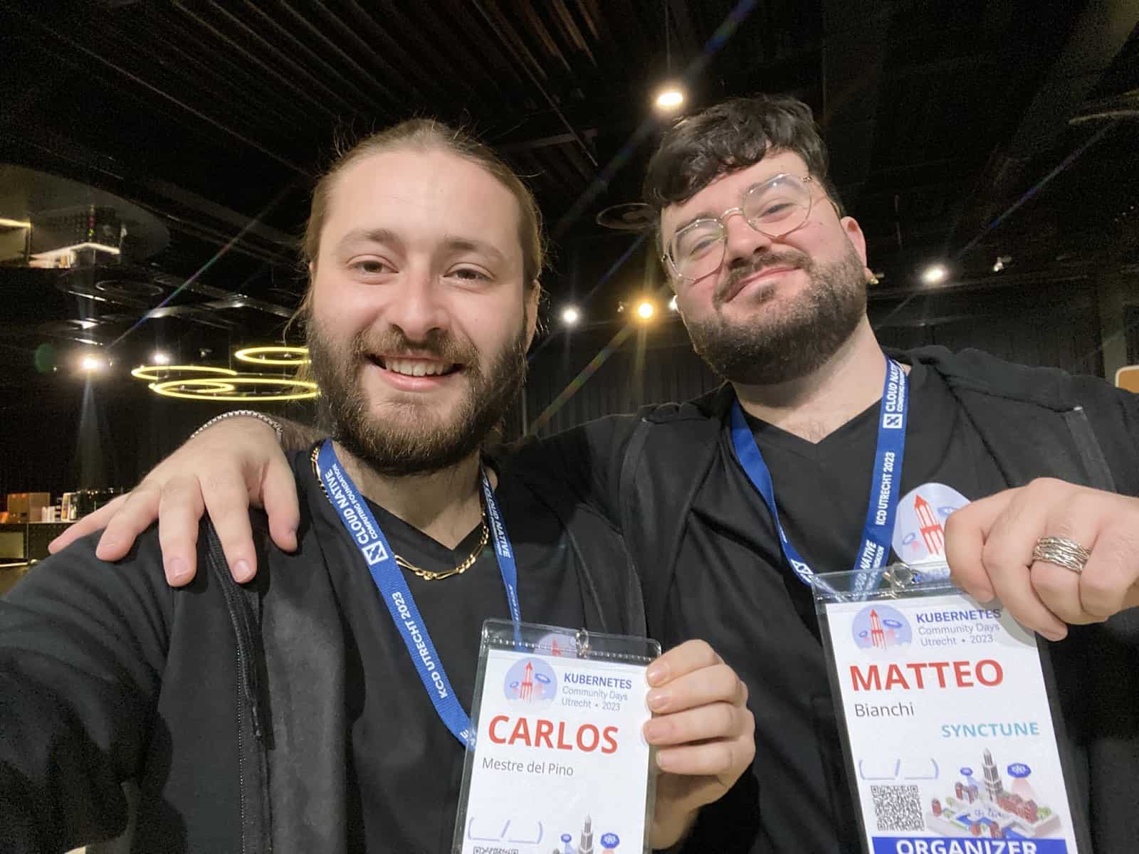 Carlos and Matteo showing their name tag to the camera