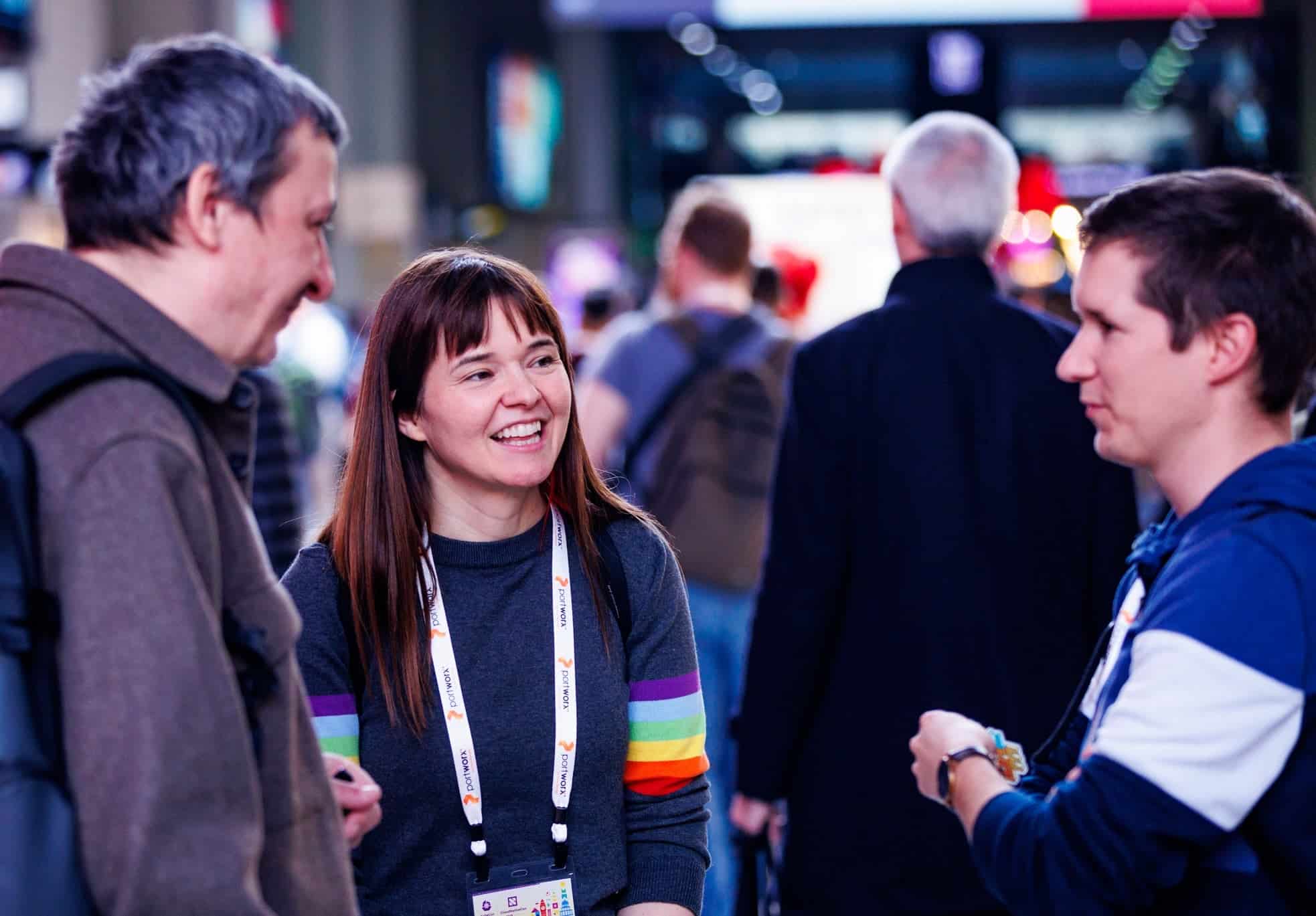 three people talking at a conference