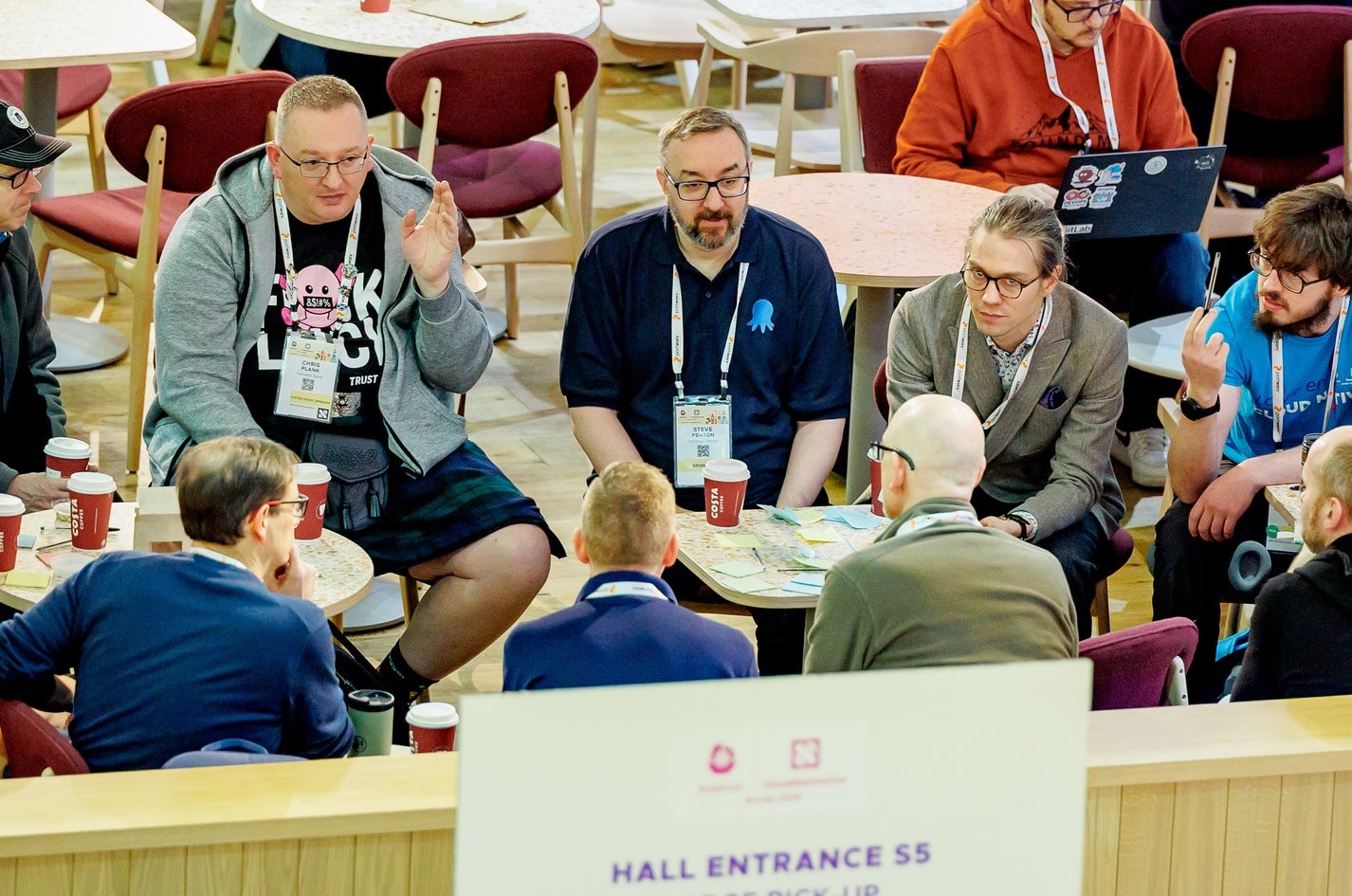 a bunch of men at a conference discussing