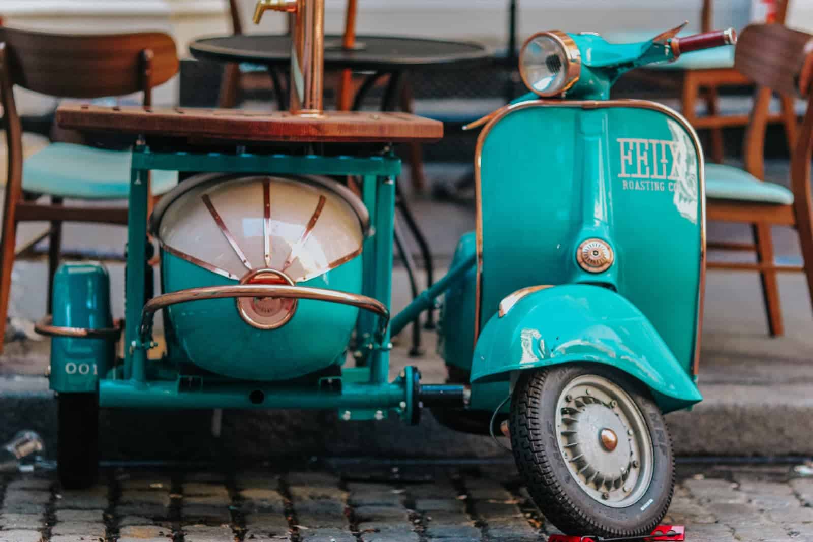 Turquoise colored Vespa with "Felix Roasting Co" sticker