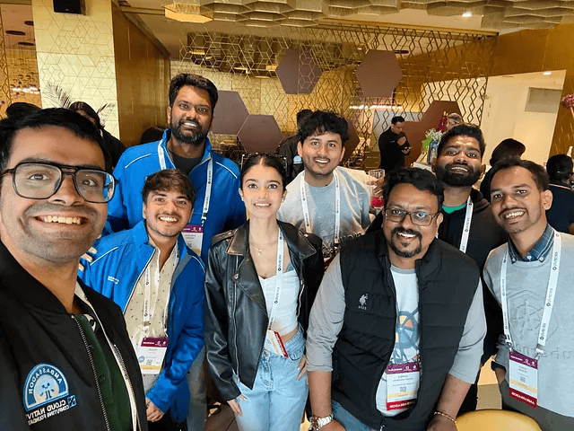A photo group image of KCD organizers Chamod Perera, Kemila De Silva, and Suresh, with a group of colleagues, attending KubeCon India 2024