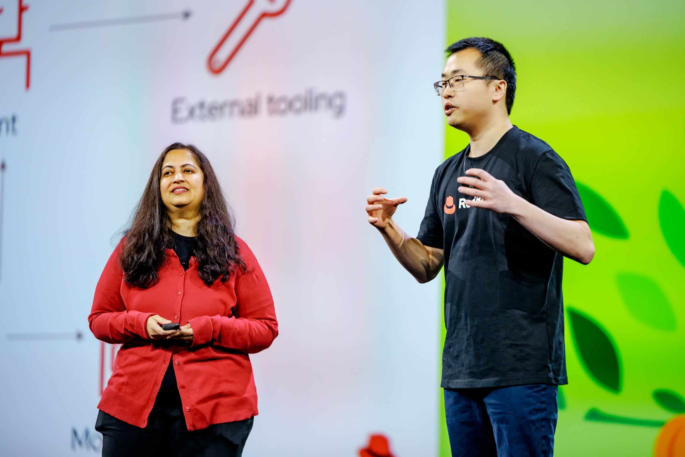 man and woman talking on a stage